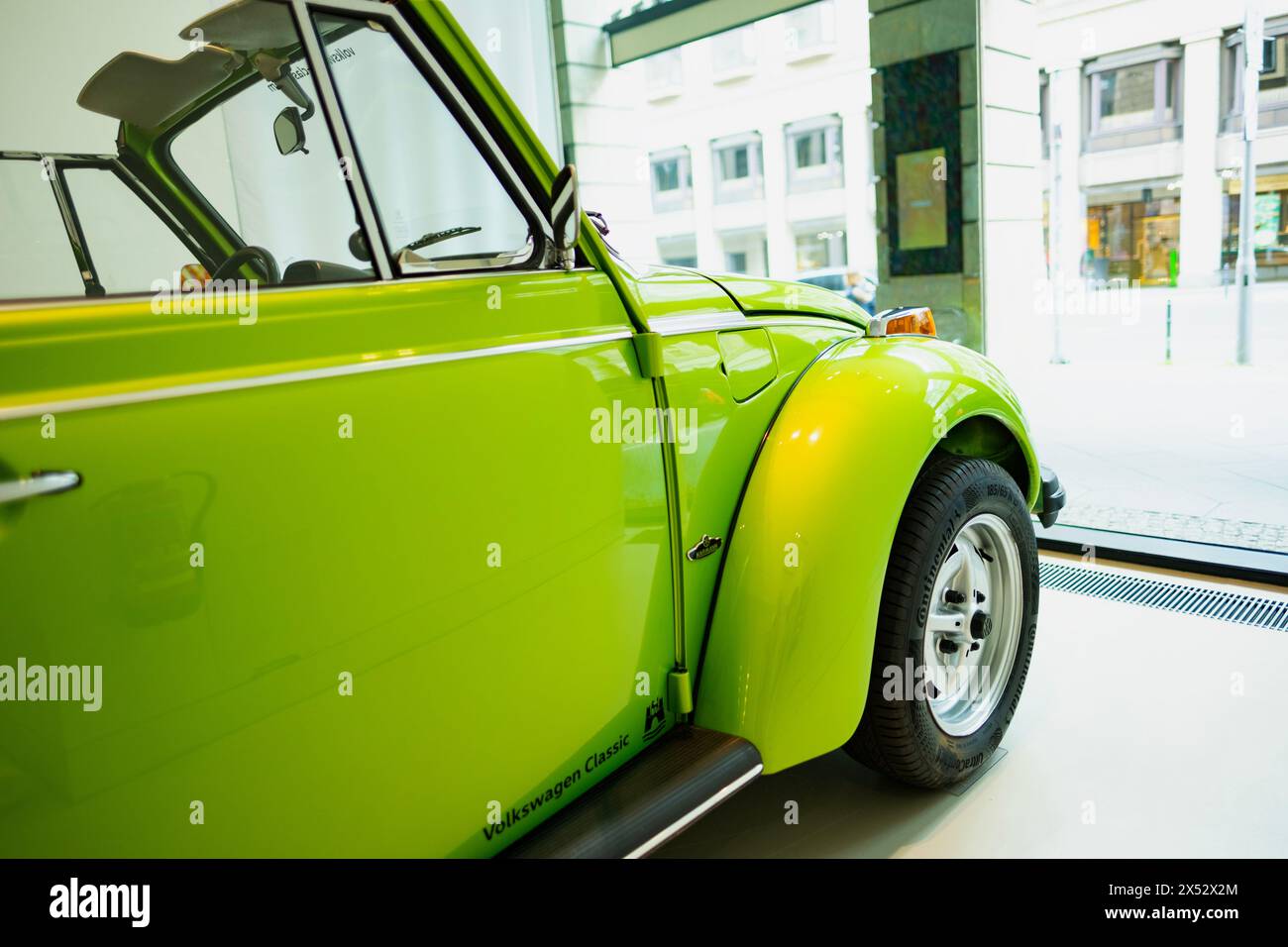 classic green vintage car Volkswagen VW Beetle Cabriolet, automotive nostalgia, display Iconic show Volkswagen Group Forum in Berlin, Germany - April Stock Photo