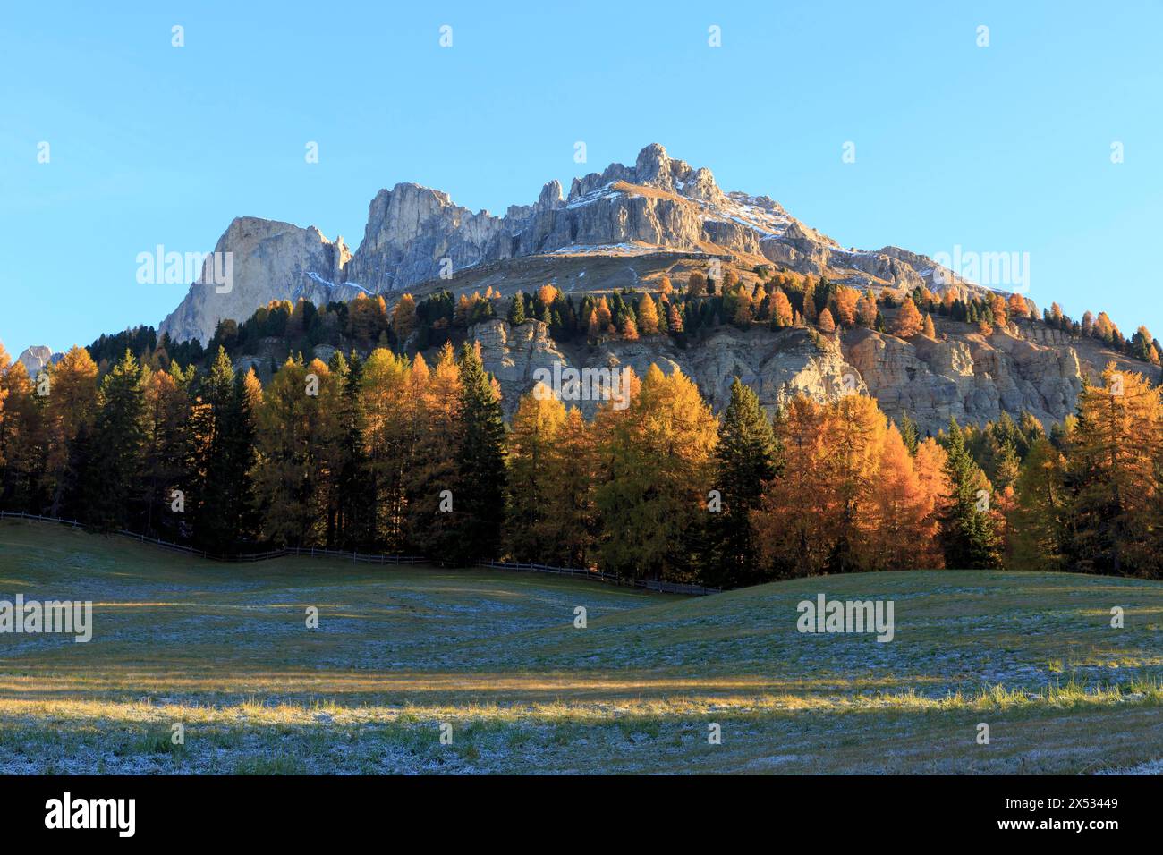 Autumn landscape with sunlit mountain peaks and colourful trees, Italy ...
