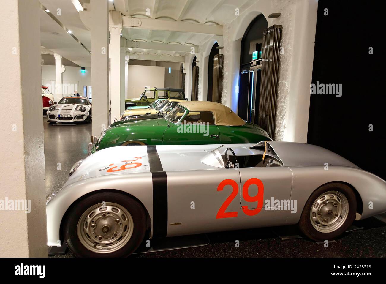 A silver Porsche racing car with starting number 29 is parked among other classic cars, AUTOMUSEUM PROTOTYP, Hamburg, Hanseatic City of Hamburg Stock Photo
