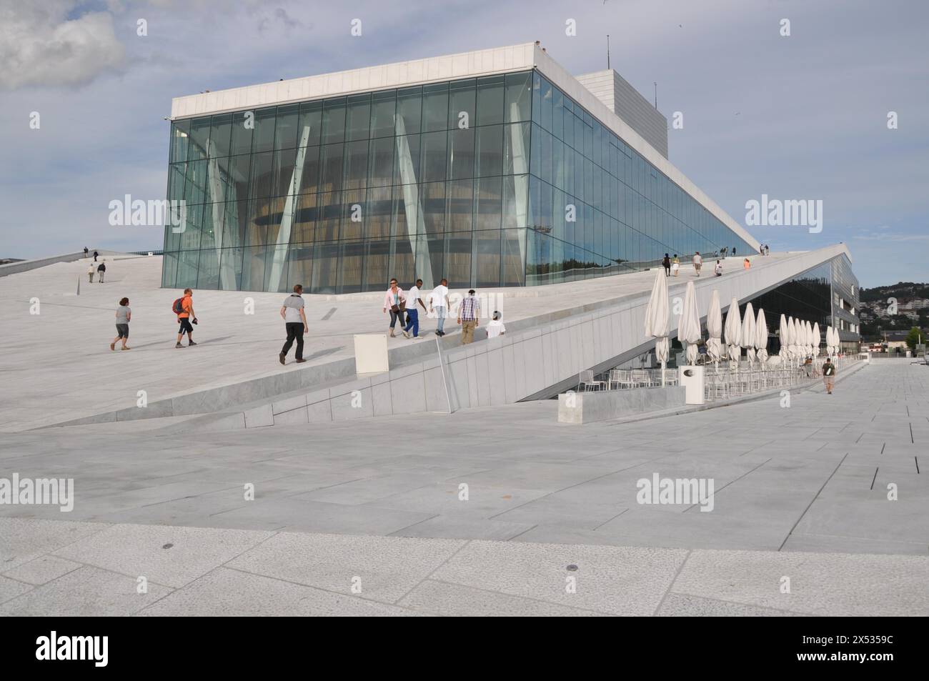 A futuristic building with people walking on the roof, wide glass front, new opera house, Oslo, Norway Stock Photo