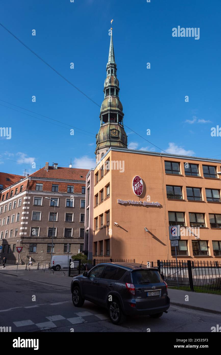 St Peter's Church, considered the cradle of the Reformation in the Baltic States, in front of that grammar school, Riga, Latvia Stock Photo