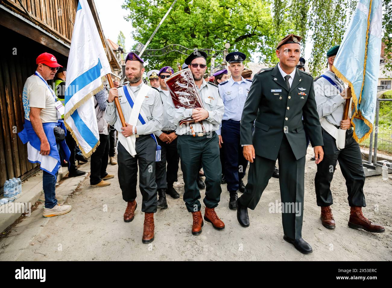 Israeli military walk in the March of the Living 2024 at Auschwitz Camp gate 'Work Makes you Free', with 55 holocaust survivors participating. Holocaust survivors and October 7th survivors attend the March of the Living together with a delegation from, among others, the United States, Canada, Italy, United Kingdom. On Holocaust Memorial Day observed in the Jewish calendar (Yom HaShoah), thousands of participants march silently from Auschwitz to Birkenau. The march has an educational and remembrance purpose. This year's March was highly politicized due to the Israeli war in Occupied Palestine. Stock Photo