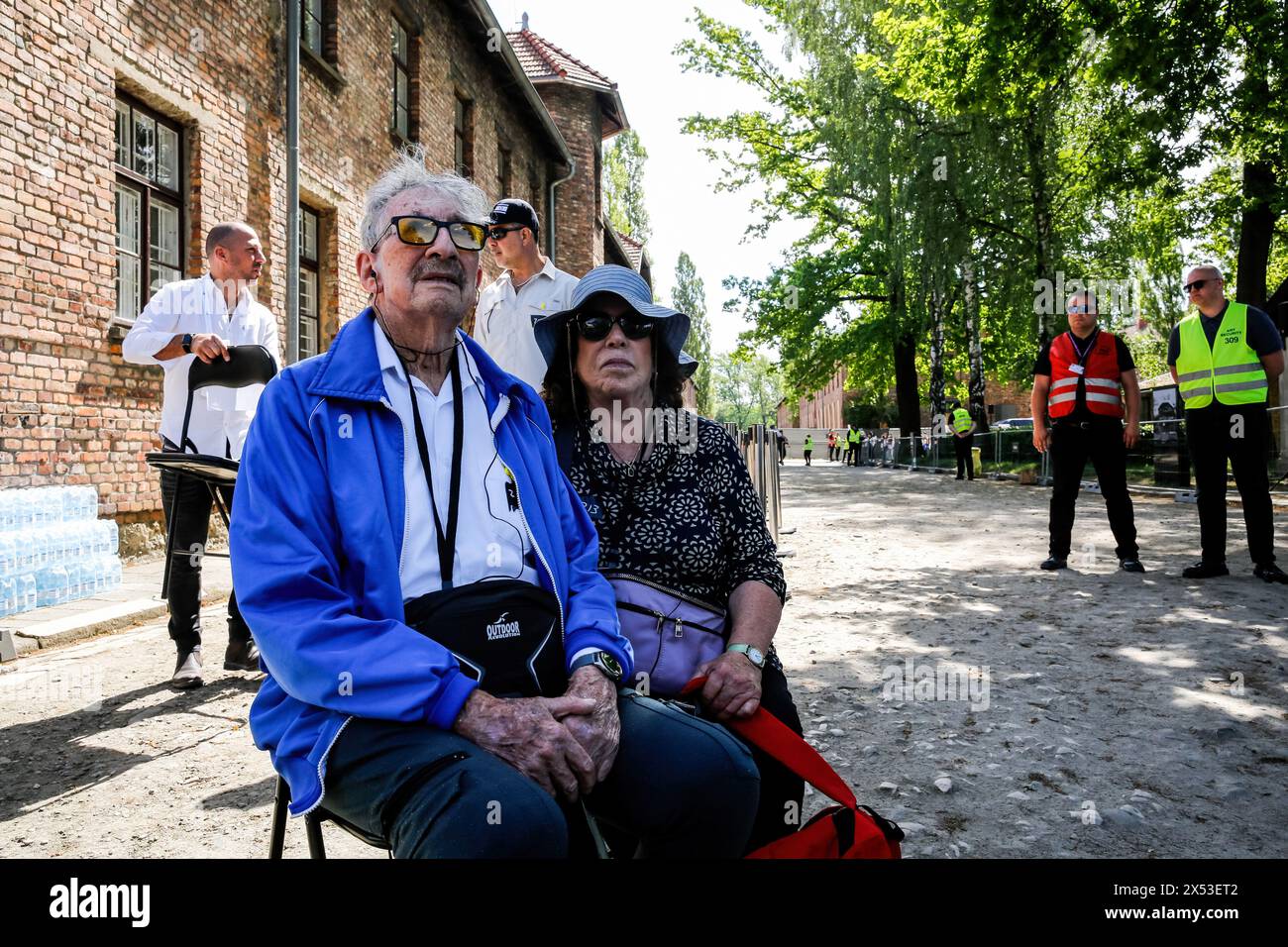 Elderly Holocaust survivors rest as they arrive for the March of the Living at Auschwitz Camp gate 'Work Makes you Free', with 55 holocaust survivors. Holocaust survivors and October 7th survivors attend the March of the Living together with a delegation from, among others, the United States, Canada, Italy, United Kingdom. On Holocaust Memorial Day observed in the Jewish calendar (Yom HaShoah), thousands of participants march silently from Auschwitz to Birkenau. The march has an educational and remembrance purpose. This year's March was highly politicized due to the Israeli war in Occupied Pal Stock Photo