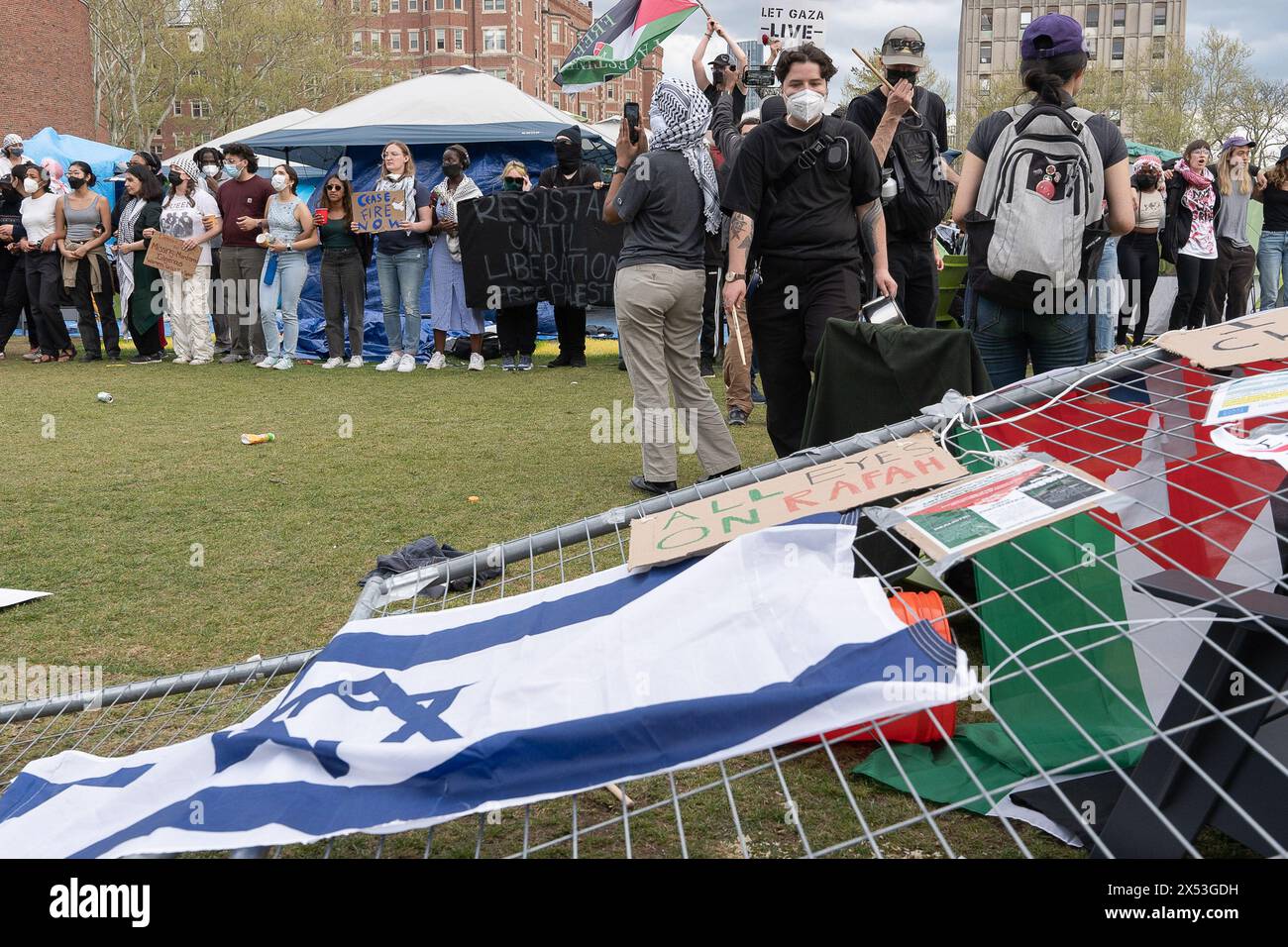 Pro-Palestine protesters lock arms after several demonstrators knocked fences down and opened the MIT encampment back to student protesters during the demonstration. Rallies continue at the Massachusetts Institute of Technology, or MIT, campus now three weeks since the pro-Palestine protesters started an encampment. Student protesters are demanding that MIT divest all involvement from the Israeli military and businesses that have ties with the ongoing war in Gaza. On May 6, 2024, MIT President Sally Kornbluth gave students a 2:30 PM EST deadline to leave the encampment or face school suspensio Stock Photo
