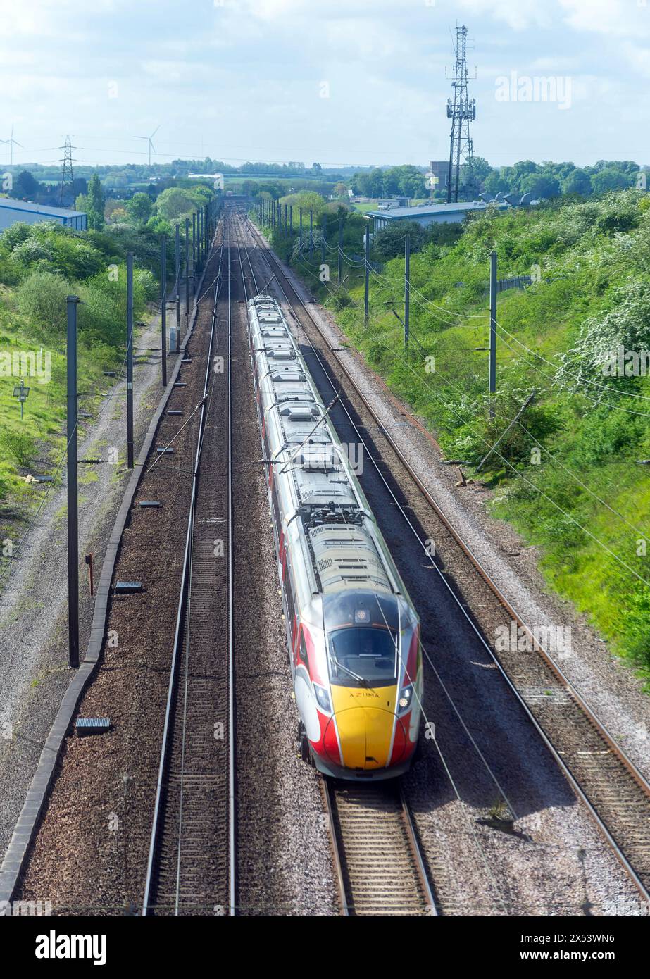 Class 801 225 races north between Huntingdon and Abbots Ripton, Cambridgeshire with a London King Cross to Edinburgh service on 4 May 2024 Stock Photo