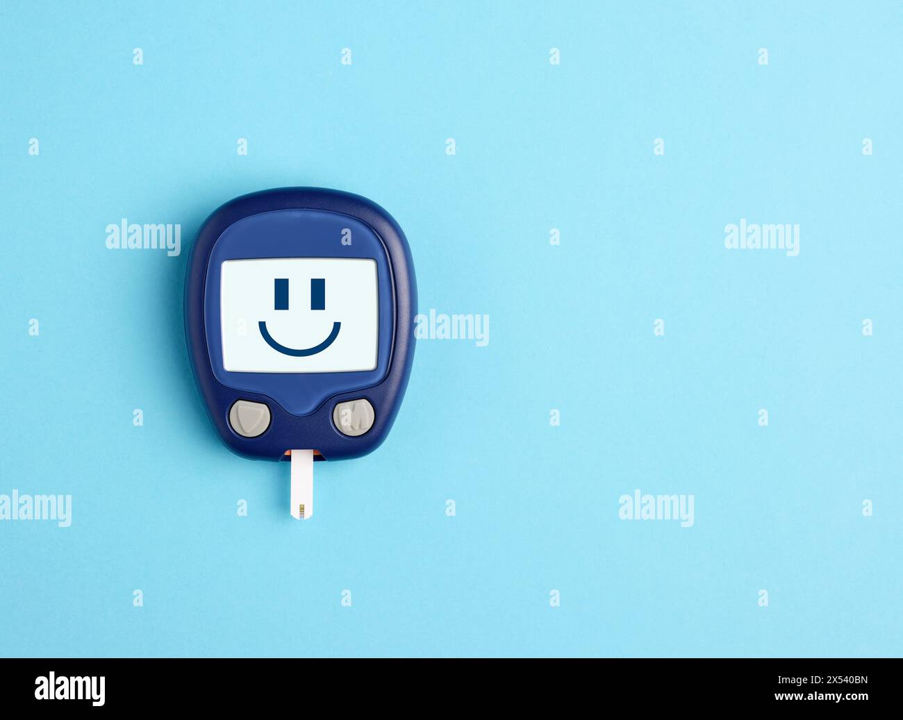 Normal or ideal blood sugar. Health care and blood glucose testing. Glucometer with a digital smiling happy face emoticon on blue background. Stock Photo