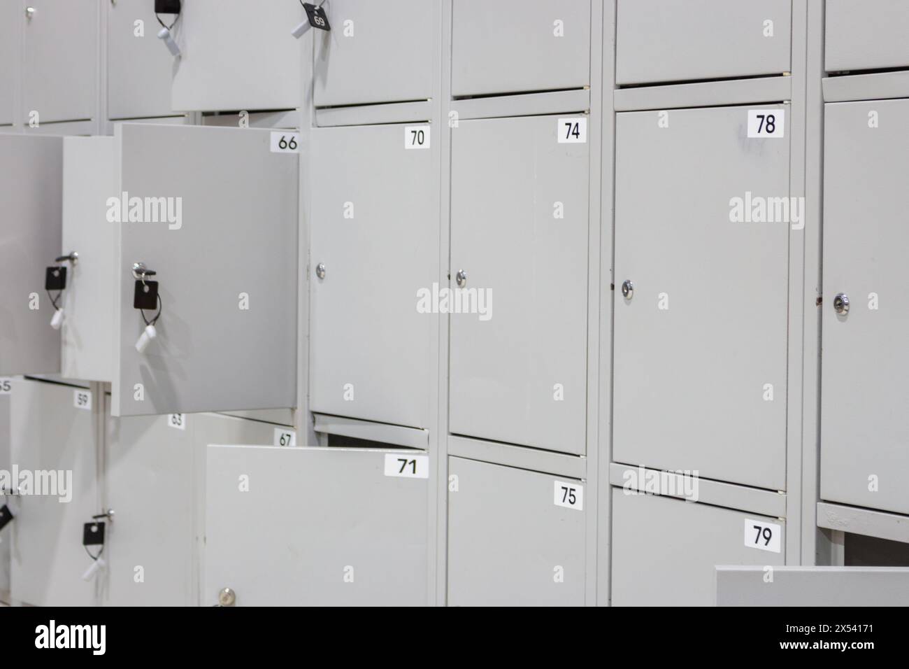 Metal luggage storage at shopping mall. Safe lockers in public place. Locker room with  numbered boxes. Private safety in supermarket. Secure in gym. Stock Photo
