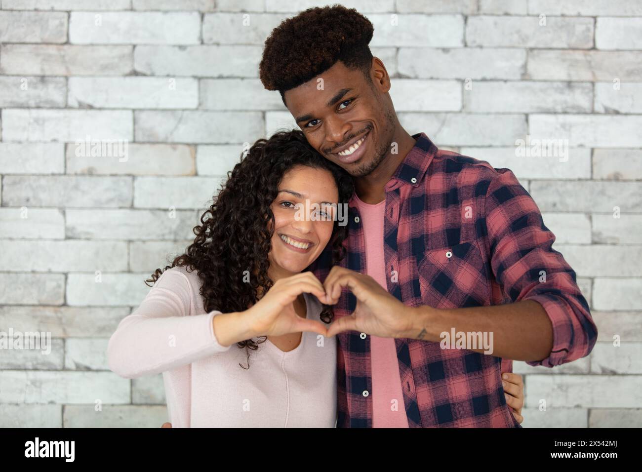 happy couple making heart shape with hands Stock Photo - Alamy
