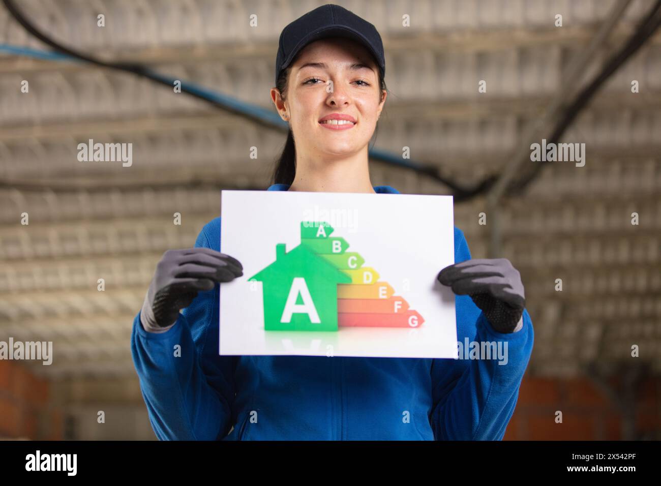 female construction site engineer holding energy building board Stock Photo