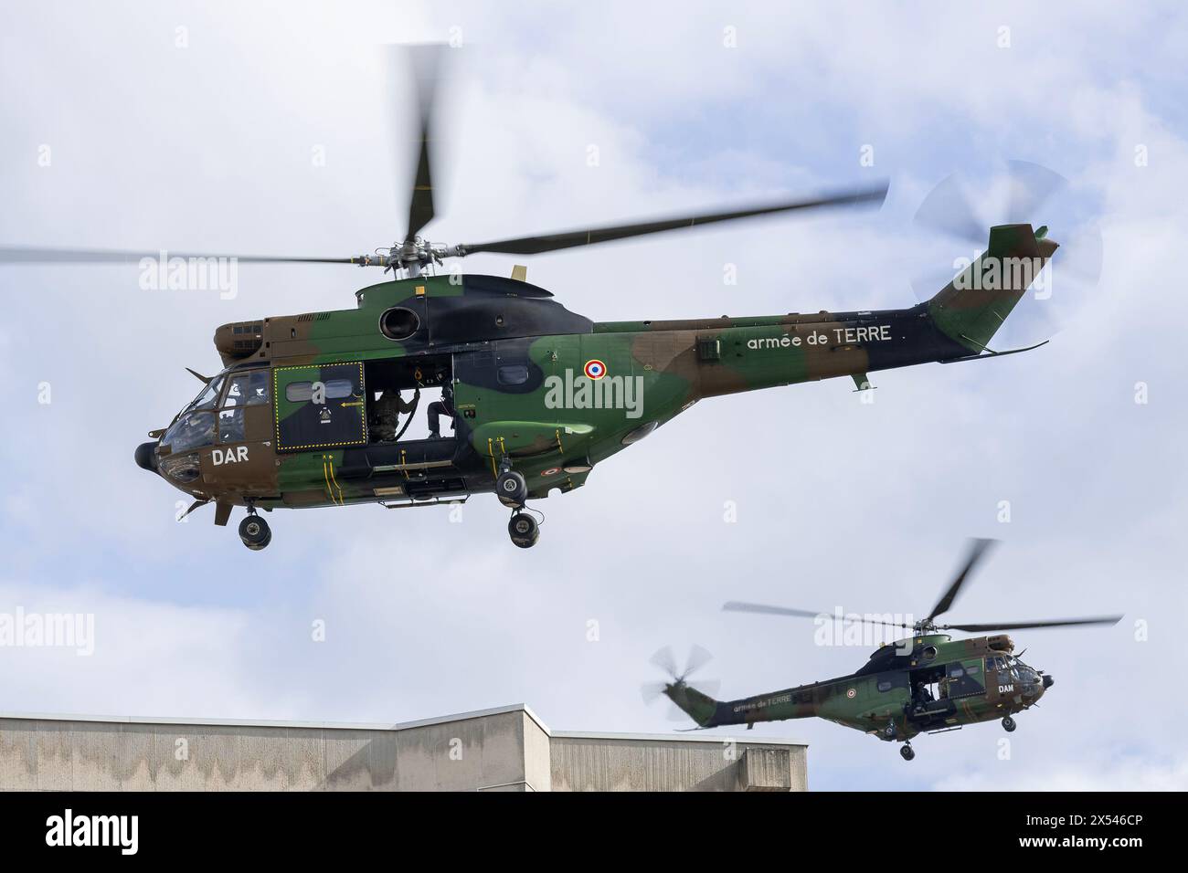 Two helicopters Aérospatiale SA-330B Puma from French Army for an exercise to drop members of the RAID by helicopter on the roof of a building. Stock Photo