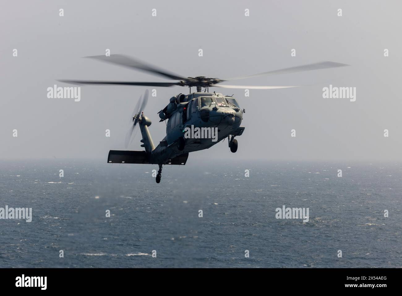 A U.S. Navy MH-60 Sea Hawk with the Helicopter Sea Combat Squadron 28, Wasp (WSP) Amphibious Ready Group (ARG) performs flight operations while the WS Stock Photo