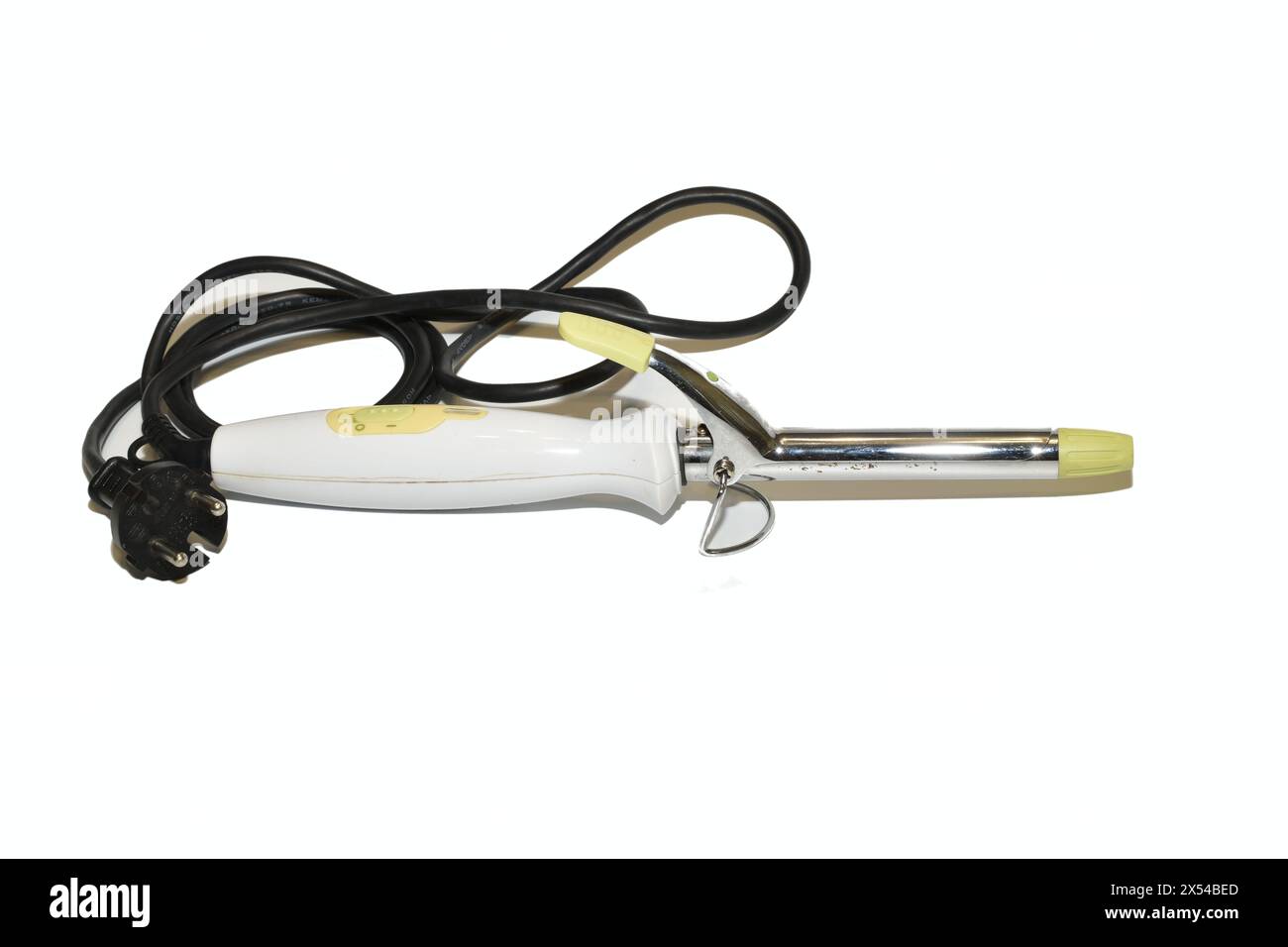 Electric hair curling iron lies on a white background. Stock Photo