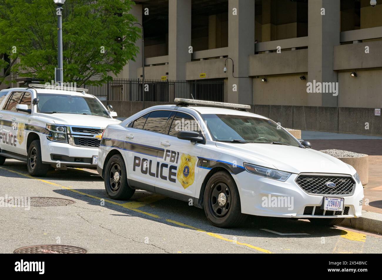 Washington DC, USA - 30 April 2024: Police patrol cars used by the FBI parked on a street outside the J Edgar Hoover headquarters building Stock Photo