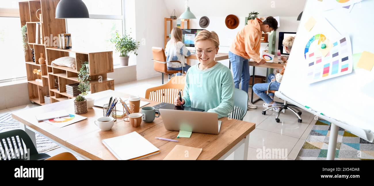 Female graphic designer working at table in office Stock Photo