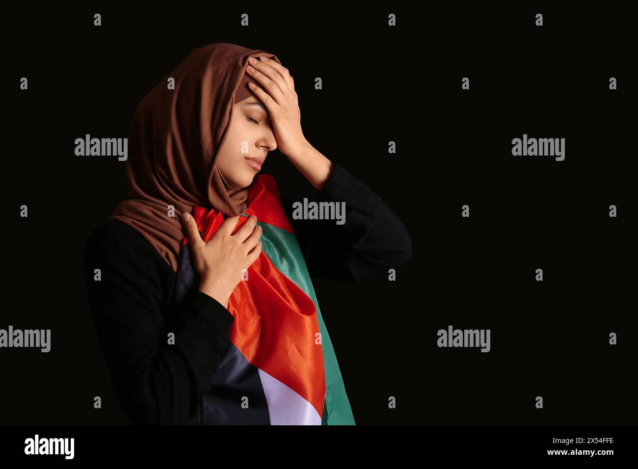 Young Muslim woman with Palestine flag crying on black background ...