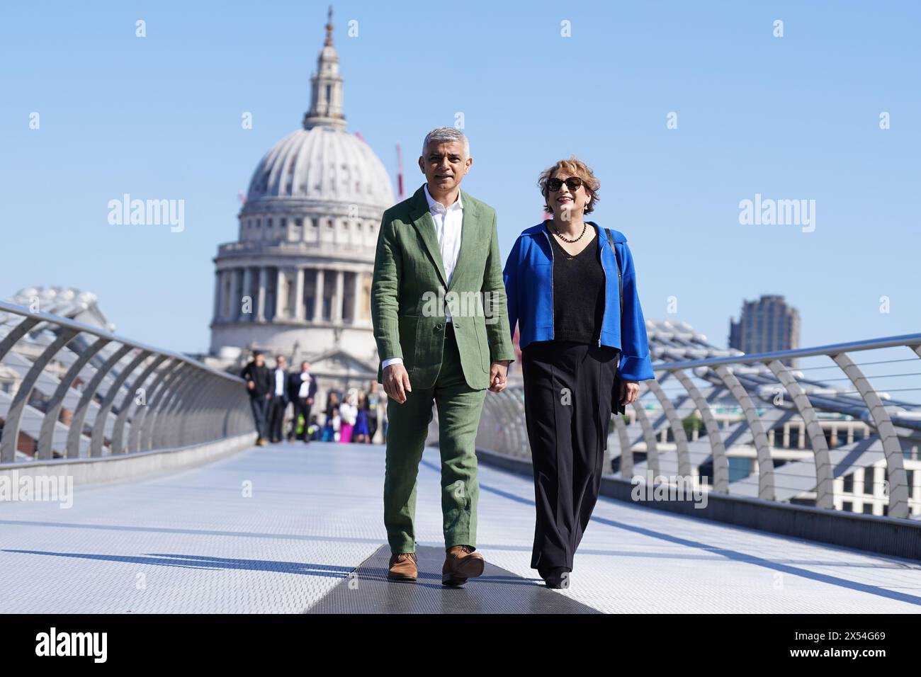 Sadiq Khan and his wife Saadiya Khan walk across the Millennium Bridge toward the Tate Modern in London, where he will sign the Declaration of Acceptance of Office to begin his third term as the Mayor of London. Picture date: Tuesday May 7, 2024. Stock Photo