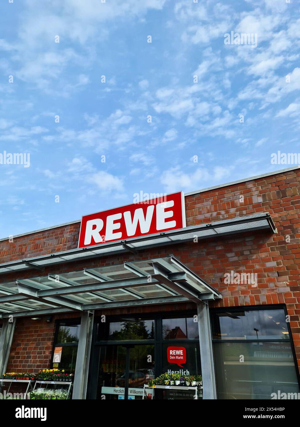 Rewe Store Germany Kiel, Germany - 04. May 2024: The logo of the discount chain REWE above ...