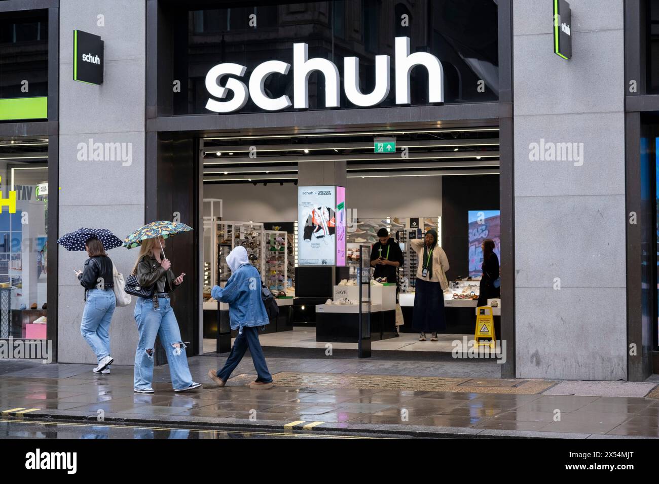 Bank holiday Monday rain does not discourage the many shoppers and visitors out on Oxford Street who brave the bad weather on 6th May 2024 in London, United Kingdom. Oxford Street is a major retail centre in the West End of the capital and is Europes busiest shopping street with around half a million daily visitors to its approximately 300 shops, the majority of which are fashion and high street clothing stores. Stock Photo