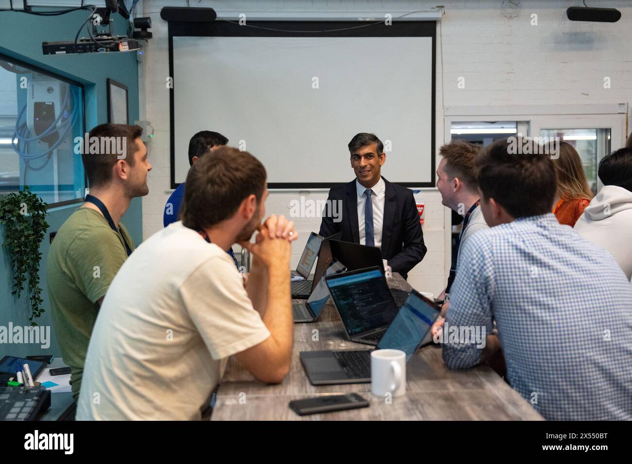 Prime Minister Rishi Sunak (centre) talks with employees during a visit to the offices of Wayve Technologies in London. Picture date: Tuesday May 7, 2024. Stock Photo