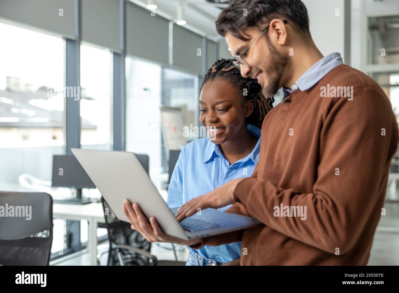 Diverse colleagues collaborating on project together Stock Photo