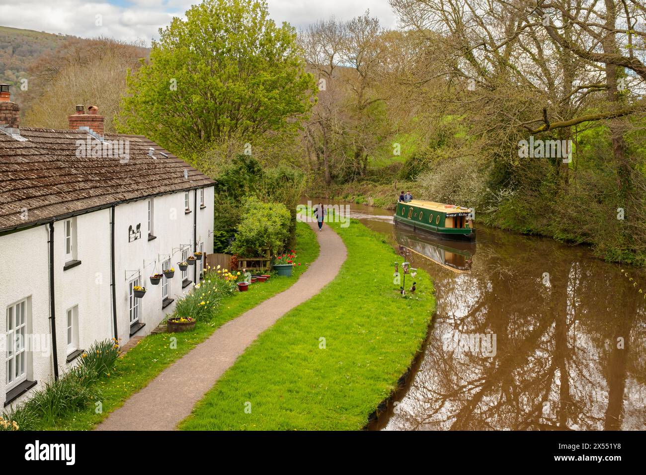 Narrowboat passing old cottages beside Monmouthshire and Brecon Canal in Brecon Beacons National Park. Talybont-on-Usk, Powys, Wales, UK, Britain Stock Photo