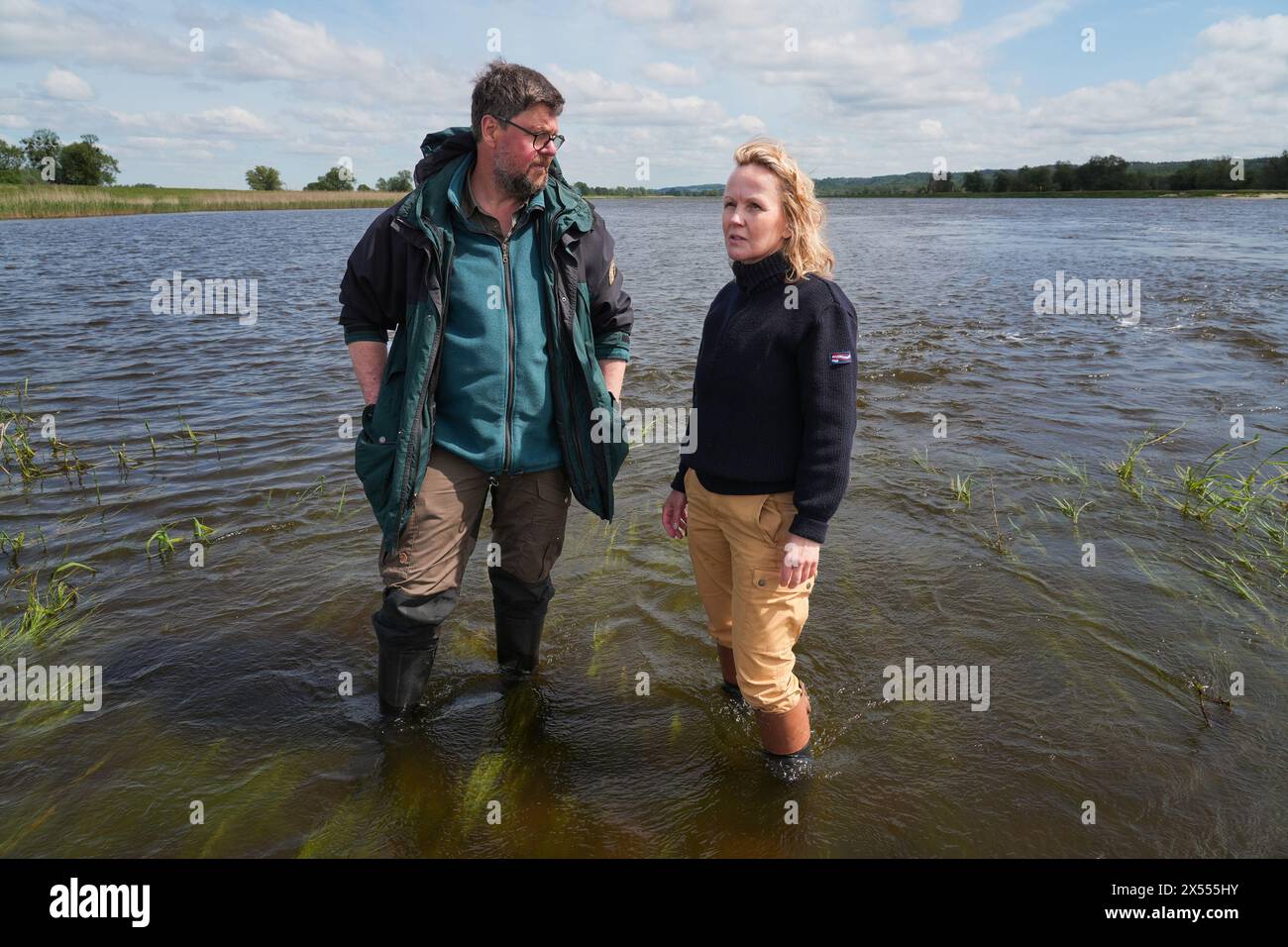 07 May 2024, Brandenburg, Schwedt/Oder/Ot Criewen: Steffi Lemke (r, Alliance 90/The Greens), Federal Minister for the Environment, Nature Conservation, Nuclear Safety and Consumer Protection, and Dirk Treichel (l), Director of the Lower Oder Valley National Park, stand and talk after releasing Baltic sturgeon into the Oder. Young sturgeons have been released into the Oder every year since 2005. The aim of the project is to reintroduce the Baltic sturgeon, which was long extinct in the Oder due to overfishing and river pollution. Photo: Soeren Stache/dpa Stock Photo