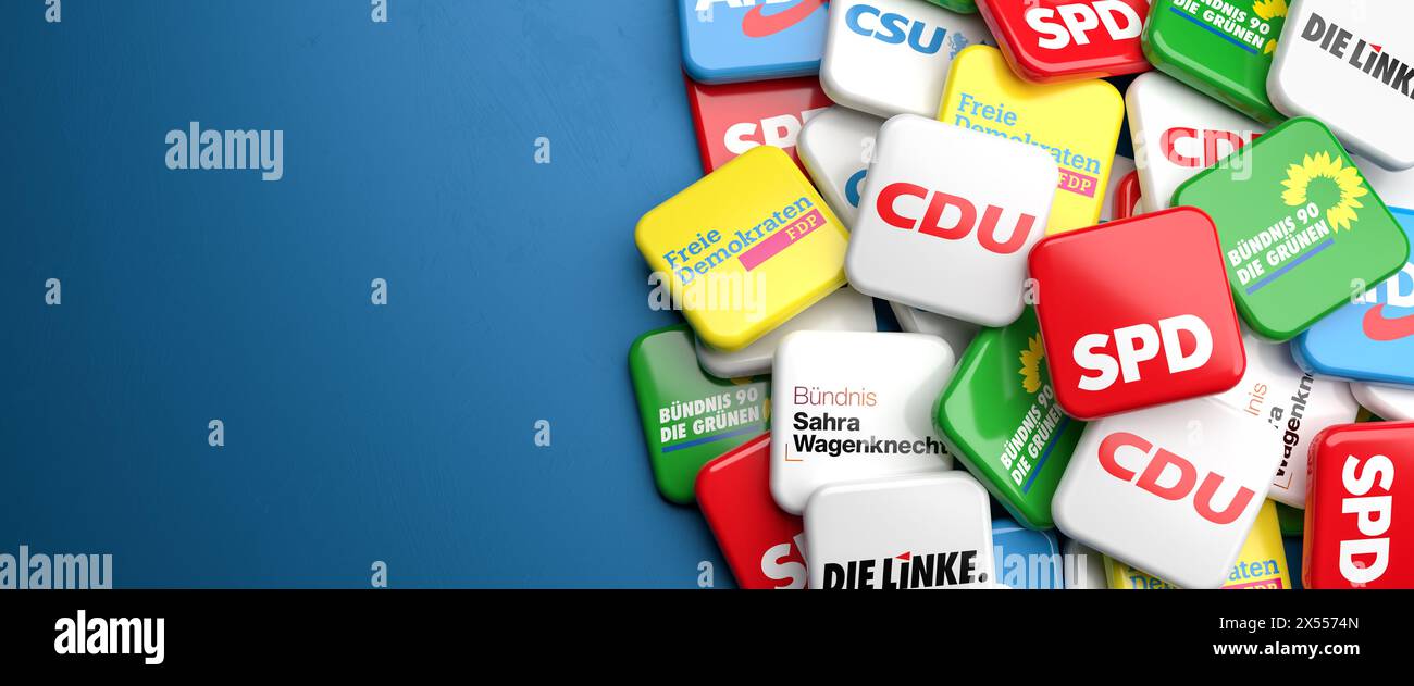 Logos of the biggest German political parties (CDU, CSU, SPD, Die Grünen, FDP, Die Linke, BSW, AfD) on a heap on a table. Copy space. Stock Photo