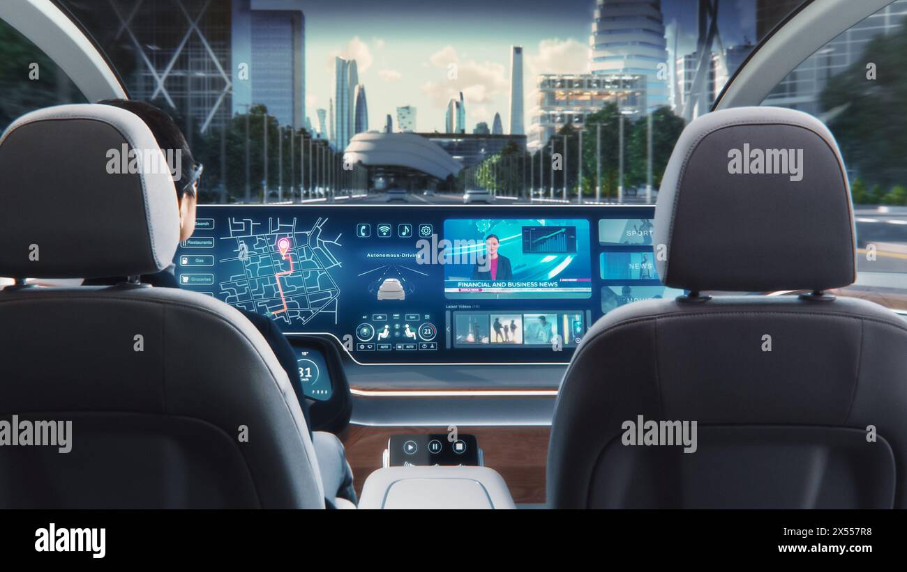 Futuristic Concept: Stylish Businessman Using Navigation App on an Augmented Reality Dashboard with Financial News Broadcast while Sitting in an Autonomous Self-Driving Zero-Emissions Electric Car. Stock Photo