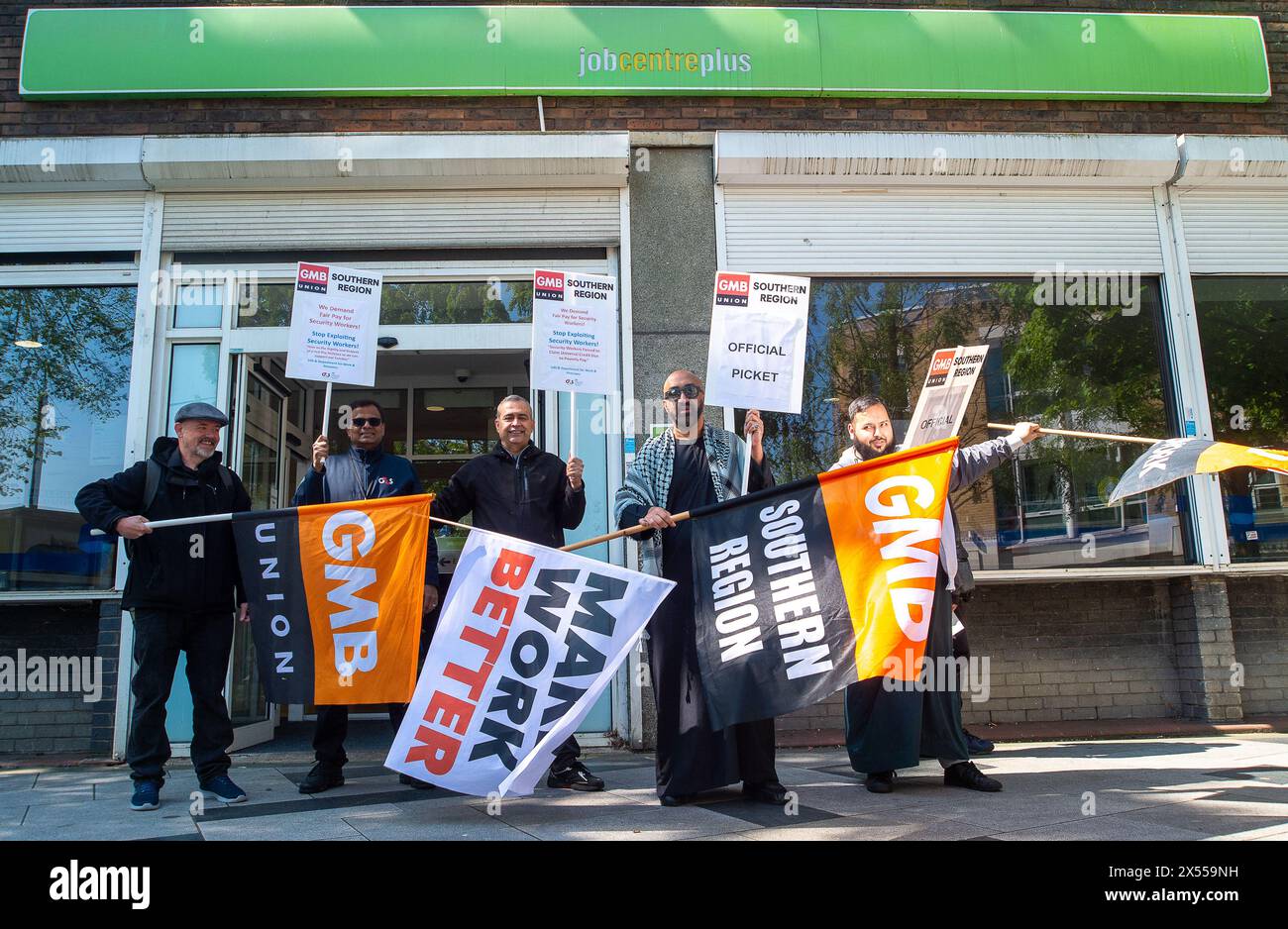 Slough, UK. 7th May, 2024. Security guards were on strike today outside the Job Centre Plus in Slough, Berkshire. They are holding a 24 hour strike in a dispute over their pay rates. GMB said more than 1,000 of its members employed by G4S will walk out today with further strike action planned for later this month. A survey of GMB members found four out of five had experienced abuse in their jobs, including being attacked by dogs and punched by members of the public. Many described daily verbal abuse, including threats to their families, racist abuse and death threats. Further strikes will take Stock Photo