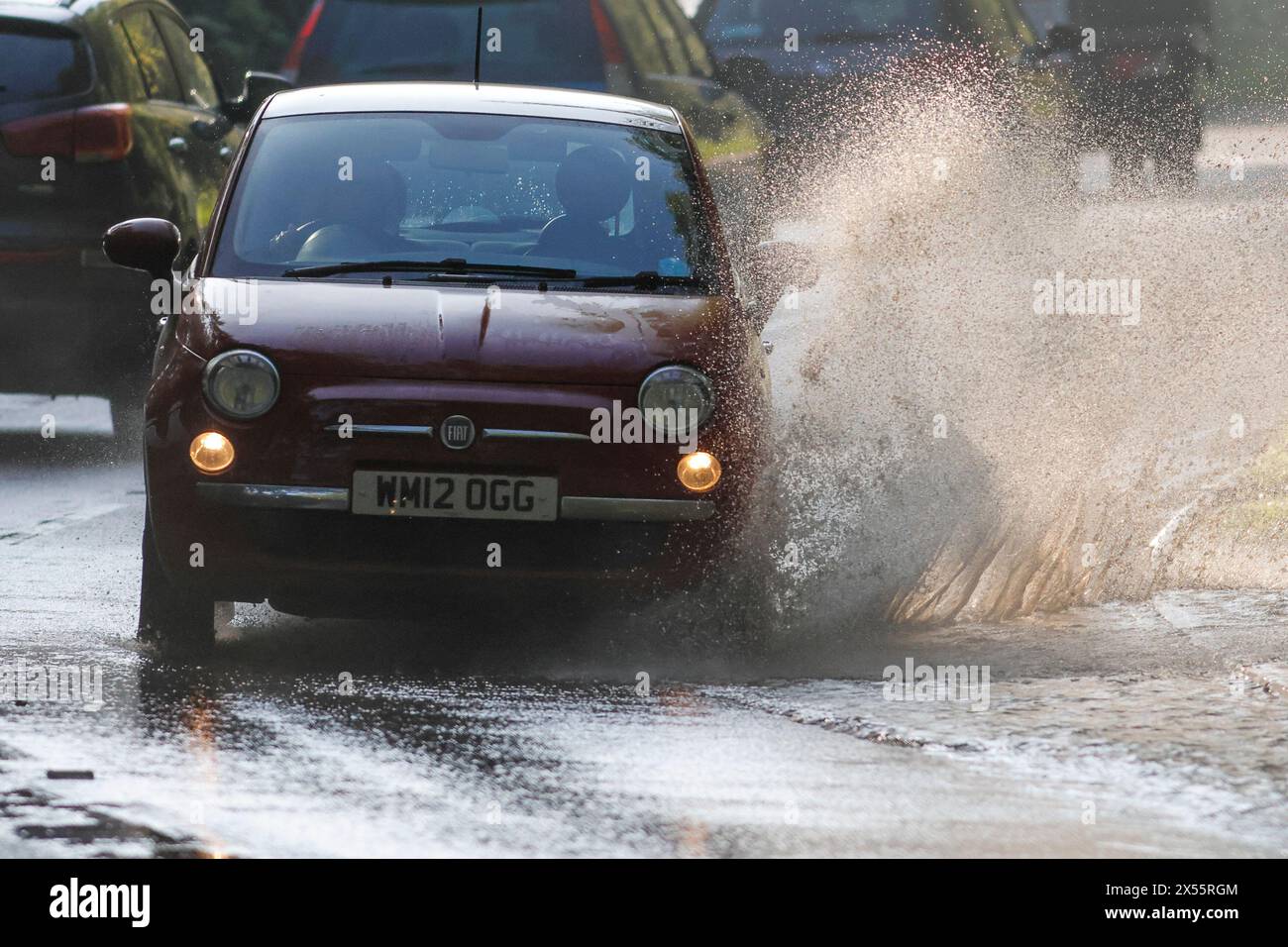 Salt Box Lane, Worplesdon. 07th May 2024. Residual surface flooding across the Home Counties this morning following yesterday's heavy rainfall. Vehicles travelling through floodwater by Brittens Pond in Worpleson, near Guildford, in Surrey. Credit: james jagger/Alamy Live News Stock Photo