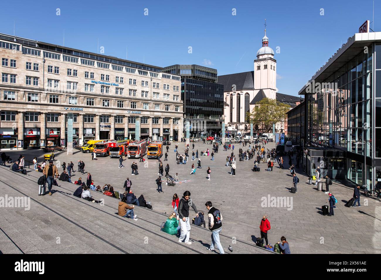 people in front of the central station, church St. Mariae Himmelfahrt, Cologne, Germany. Menschen vor dem Hauptbahnhof, Kirche St. Mariae Himmelfahrt, Stock Photo
