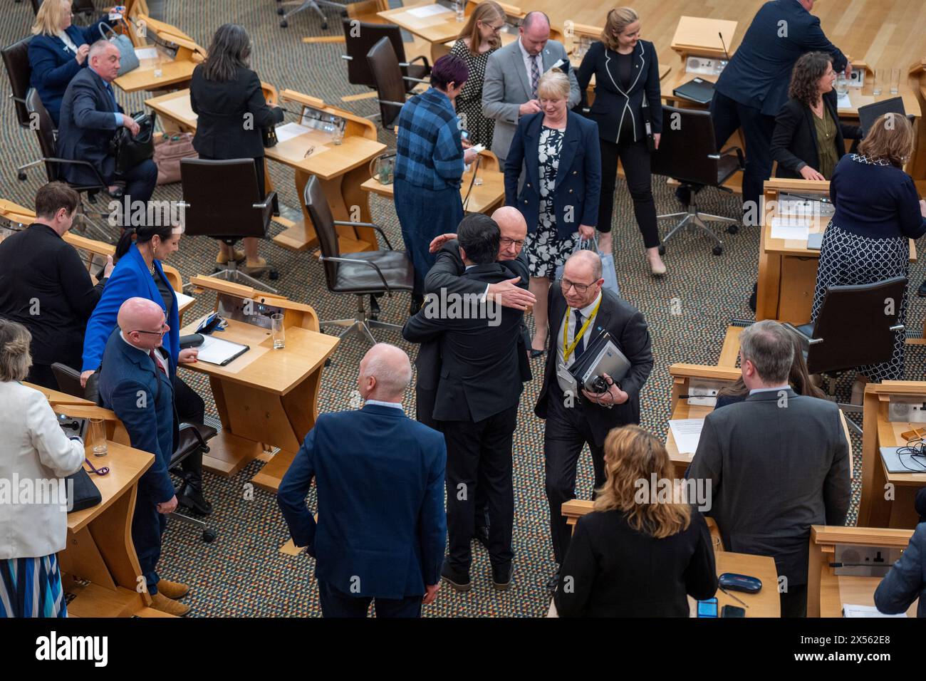 John Swinney hugs former first minister Humza Yousaf on the floor of the main chamber after being voted in as First Minister at the Scottish Parliament in Edinburgh. Picture date: Tuesday May 7, 2024. Stock Photo
