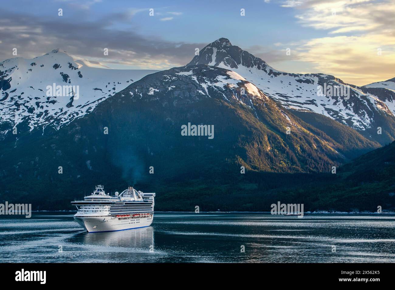 Evening sky over the Alaskan mountain range, boats on the Inside Passage. Stock Photo