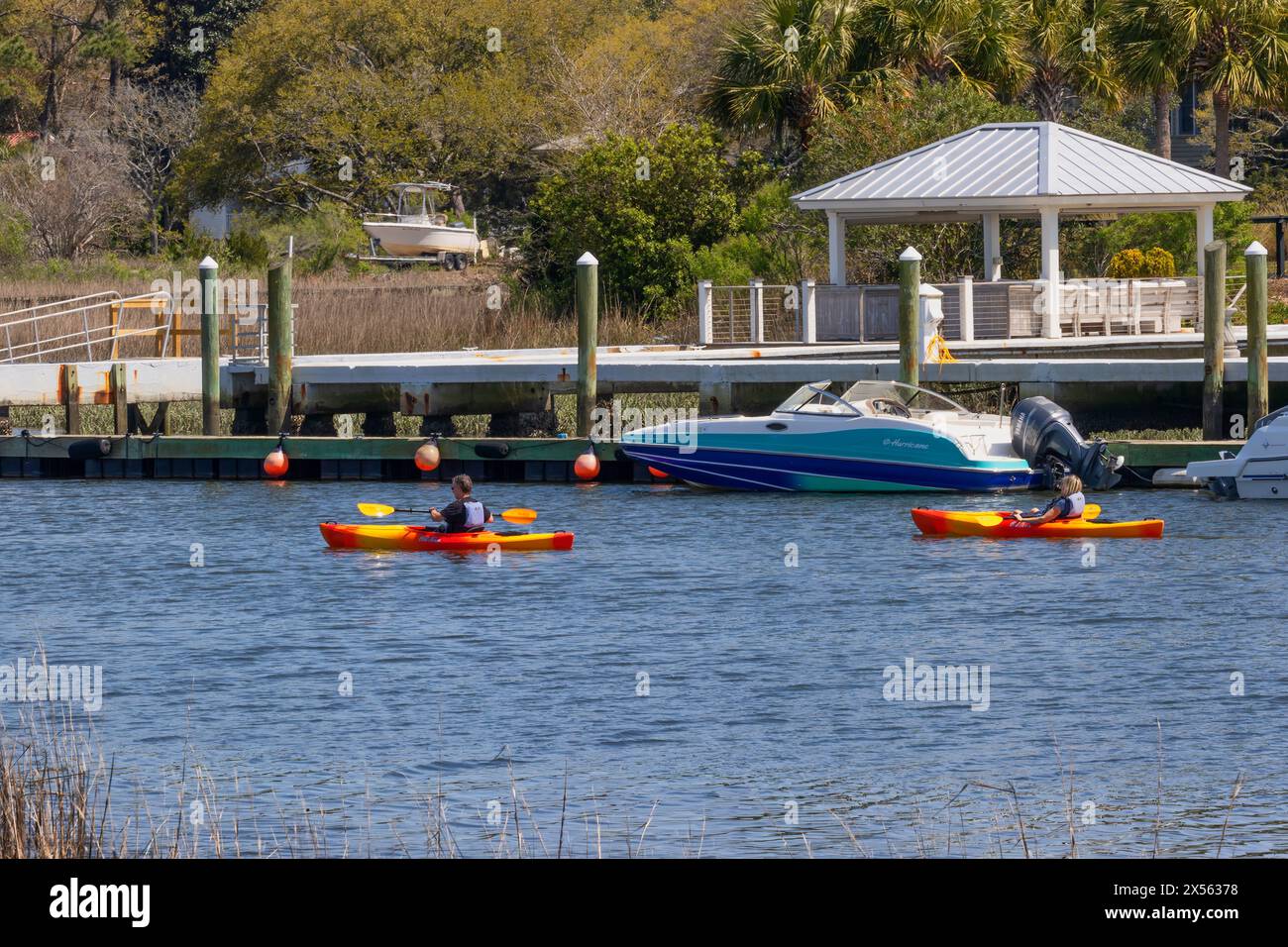 Mount Pleasant, South Carolina, USA March 20, 2024 People kayaking past docks at Shem Creek