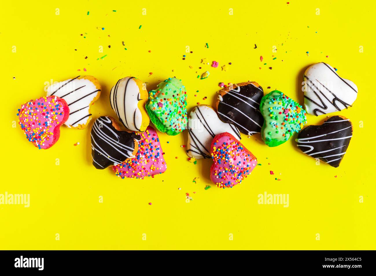 Multicolored donuts isolated on yellow background. Top view Stock Photo