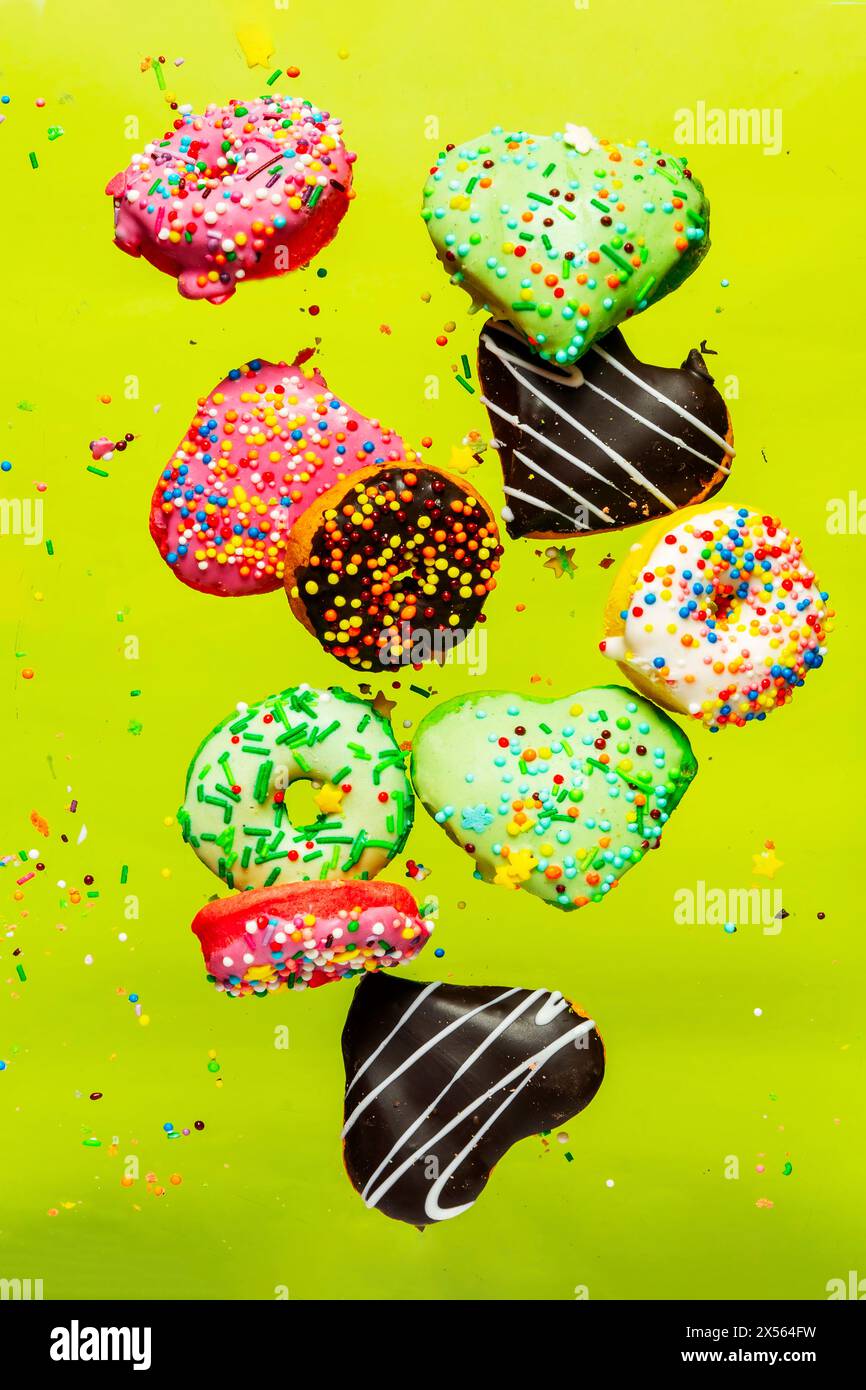 Multicolored donuts isolated on yellow background. Top view Stock Photo