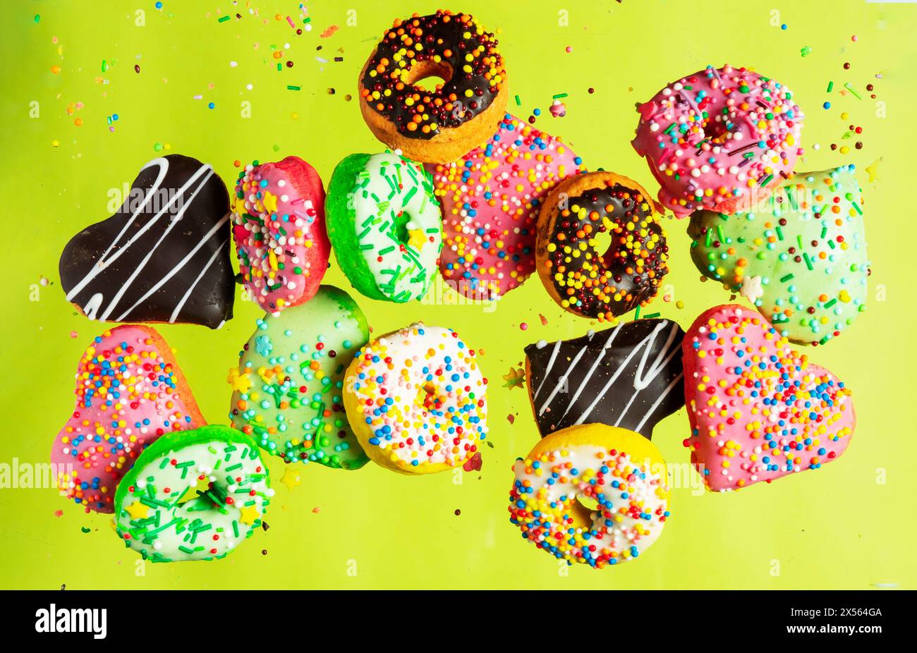Multicolored donuts isolated on yellow background. Top view Stock Photo