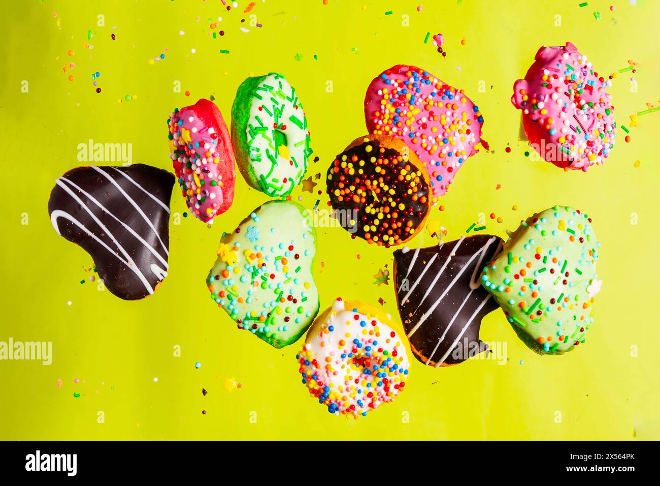 Multicolored donuts isolated on yellow background. Top view Stock Photo