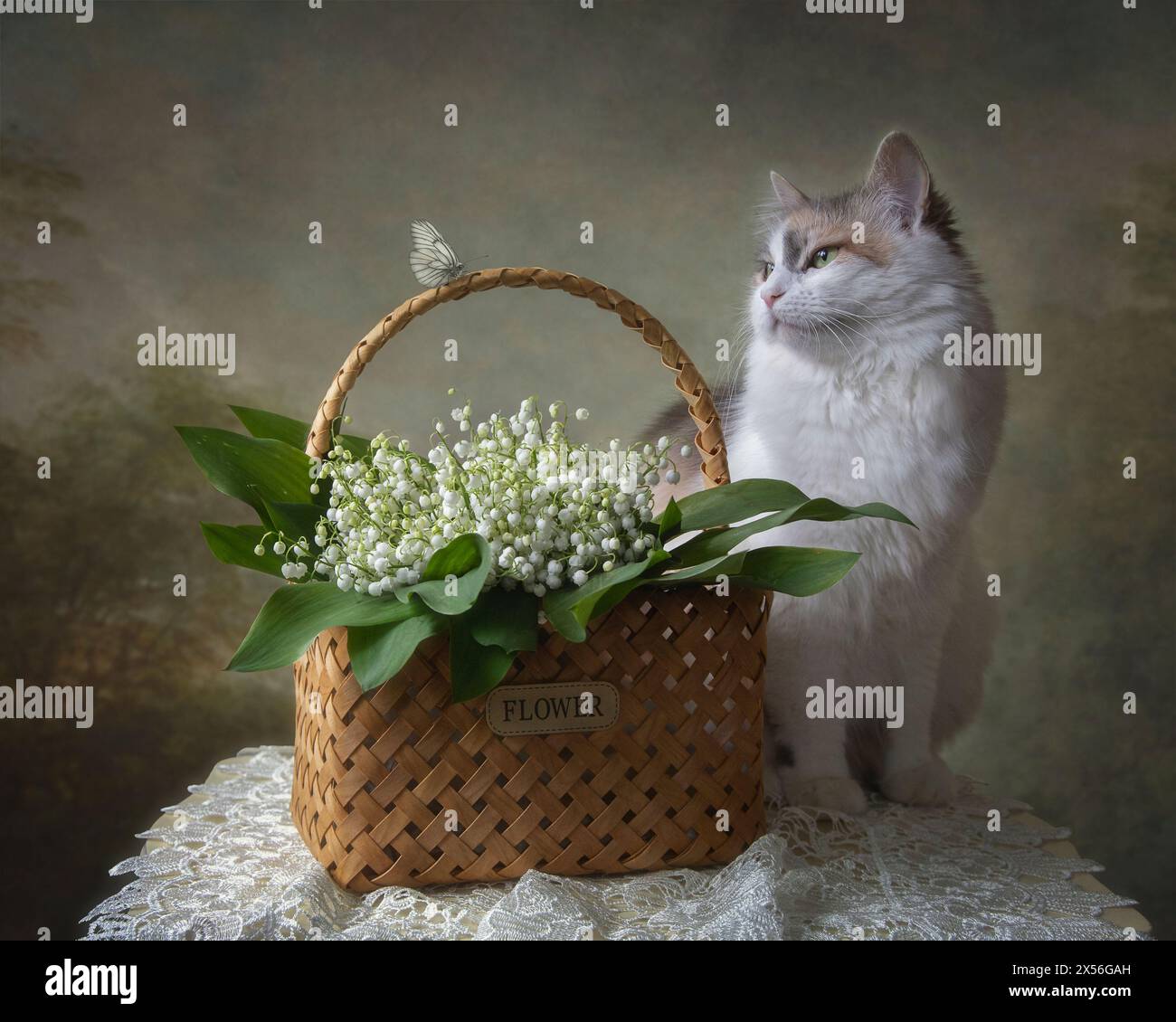 Basket with lily of the valley and pretty kitty Stock Photo - Alamy