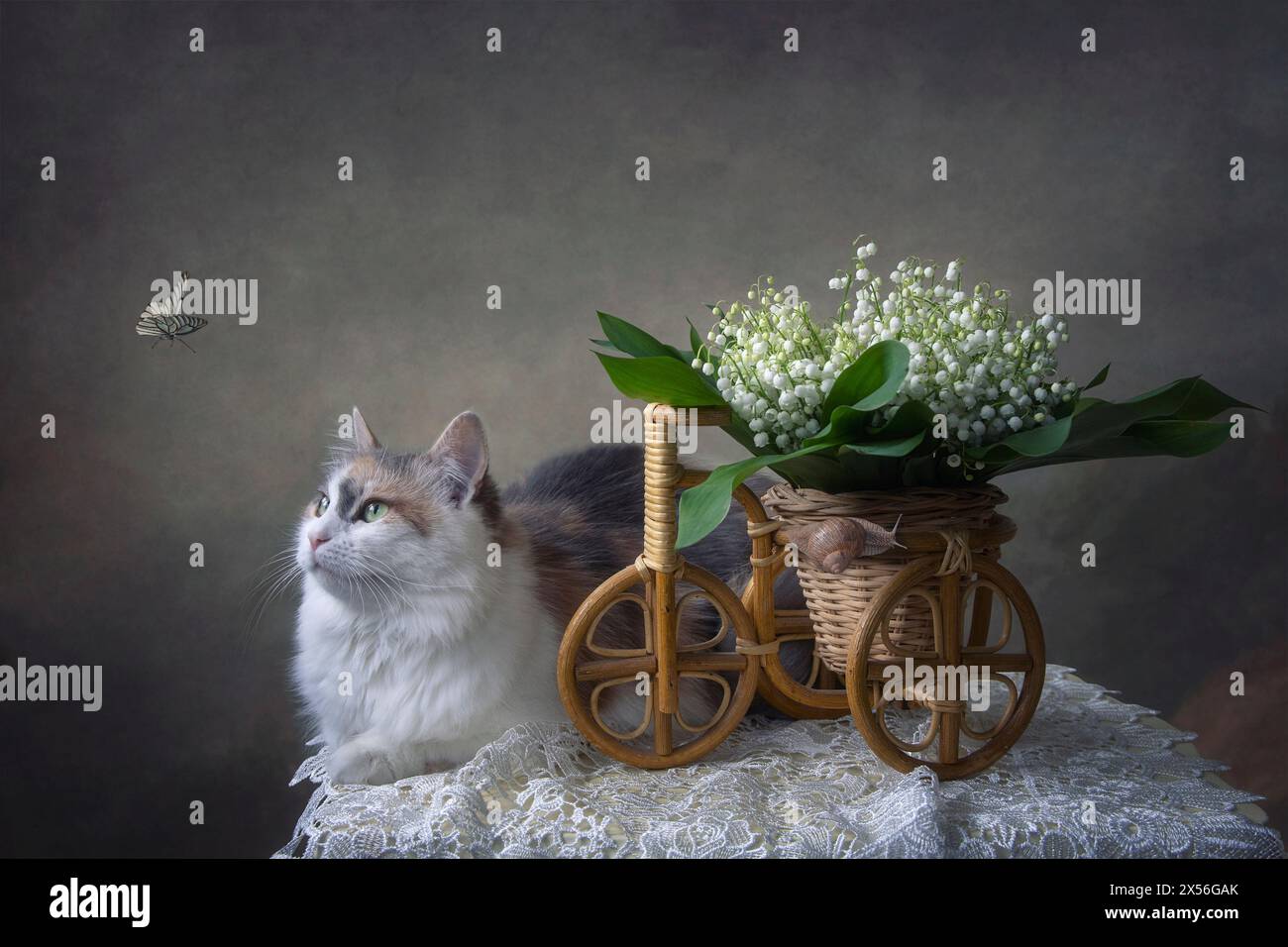 Basket with lily of the valley and pretty kitty Stock Photo - Alamy