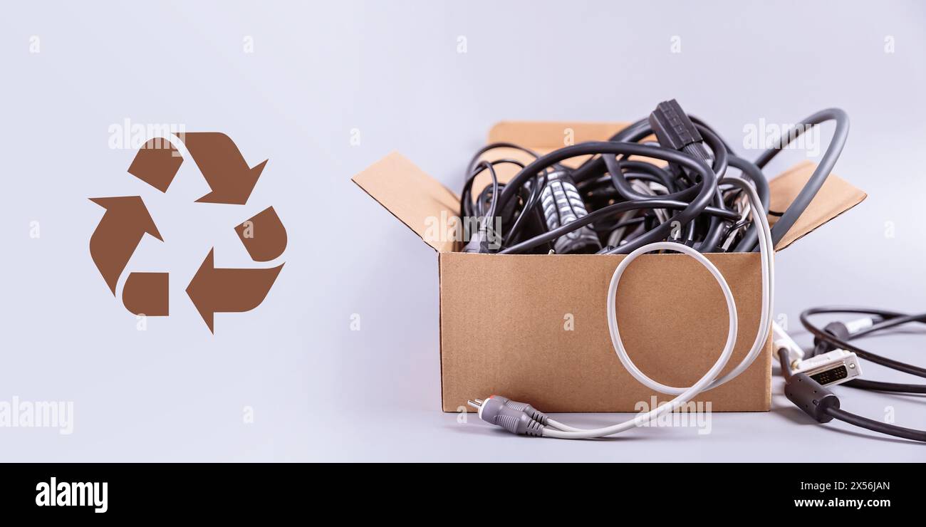 Box filled with damaged electronic gadgets and wires Stock Photo