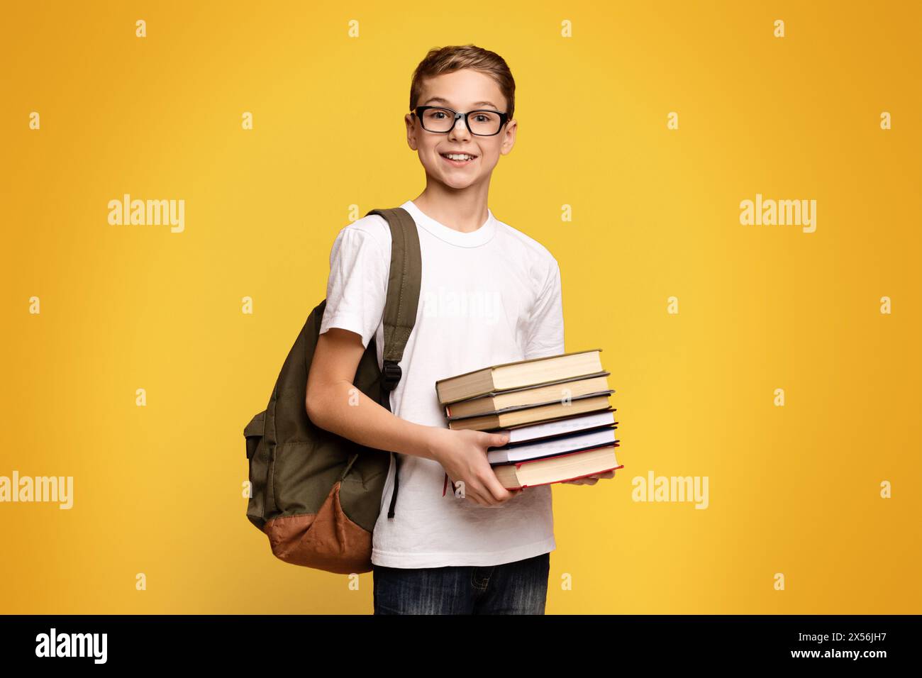 Young Boy Holding Stack of Books Stock Photo - Alamy