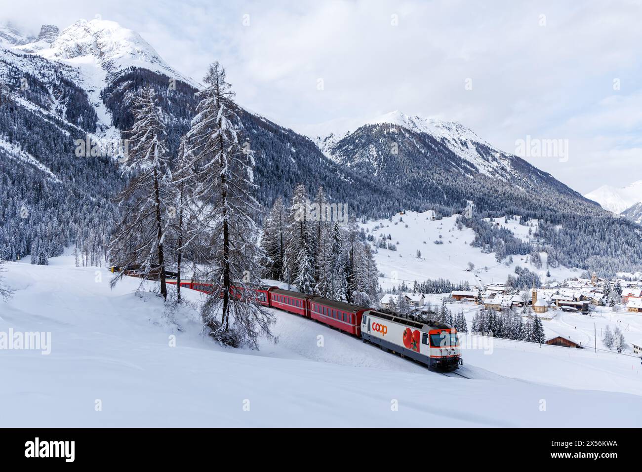 Bergün, Switzerland - January 10, 2024: Rhaetian Railway Train On The Albula Line Passenger Train In The Alps In Bergün, Switzerland. Stock Photo