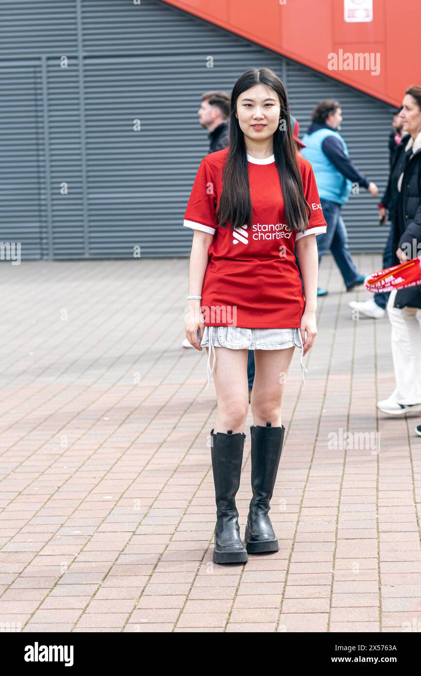 Chinese female Liverpool FC supporter posing in fron of the stadium in Anfield , Liverpool , UK . Stock Photo