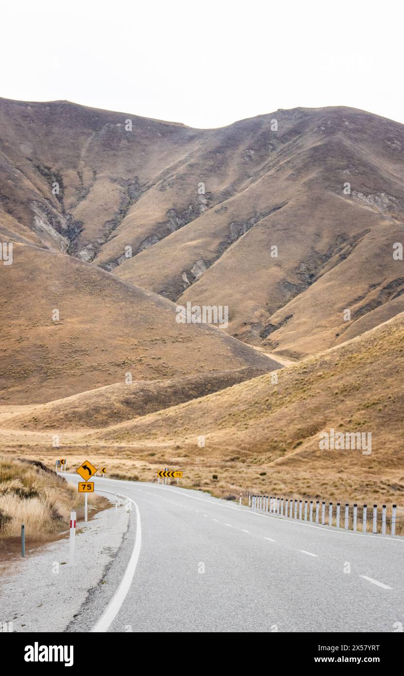 Road travelling up through Lindis Pass, State Highway 8, Central Otago, New Zealand. Stock Photo