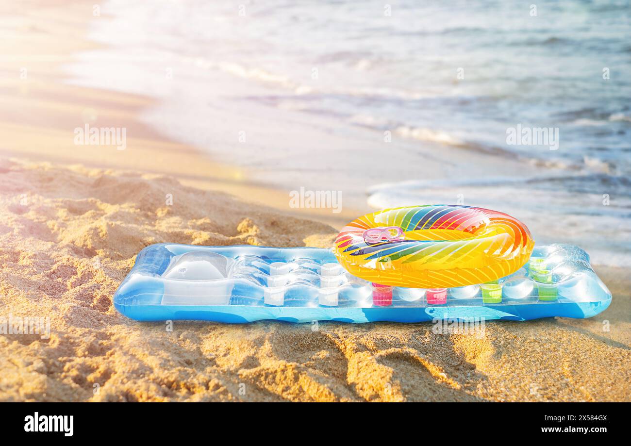 Circle and mattress for swimming on the seashore Stock Photo