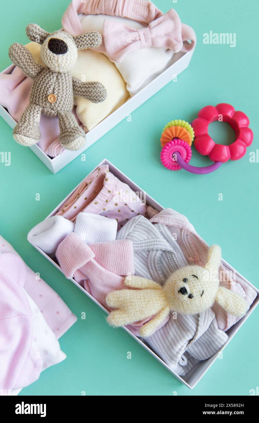 Baby and child clothes and knitted toys in carton box. Donation