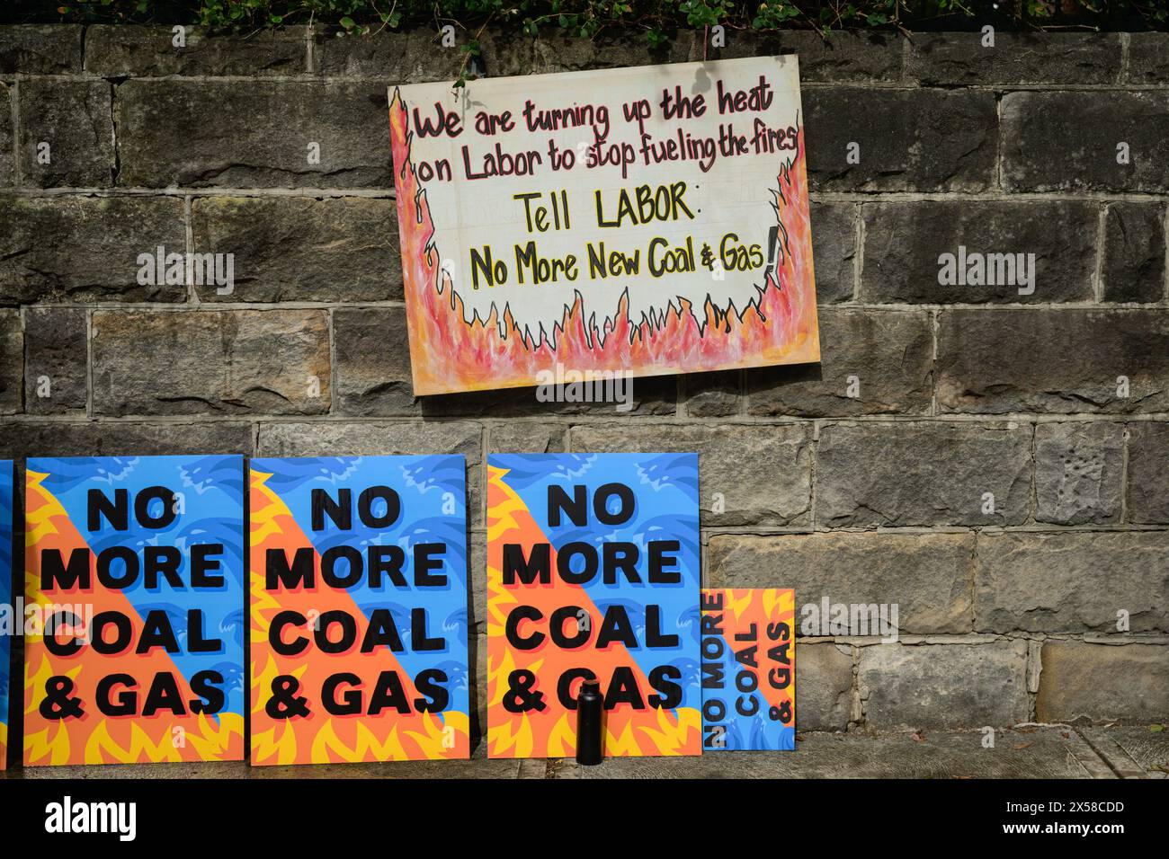 Placards seen laying on the wall of the Kirribilli House, with with inscriptions 'We are turning up the heat on Labor to stop fuelling the fires. Tell Labor: No More New Coal & Gas!' and 'No More Coal & Gas'. Protesters gathered outside the Australian Prime Minister Anthony Albaneseís Sydney residence at Kirribilli House on 8th May, in support of the climate action and protest against the Labor Government for advancing coal and gas projects in collaboration with fossil fuel companies. (Photo by George Chan/SOPA Images/Sipa USA) Stock Photo