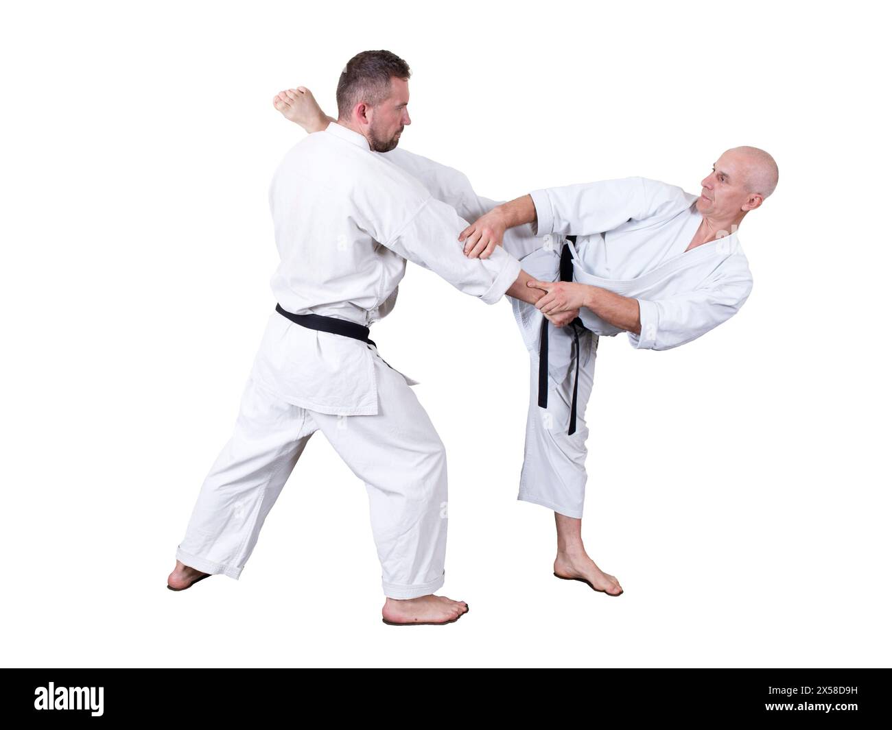 Adult athlete performs formal goju-ryu exercises. It is isolated in a white background. Close-up. Stock Photo