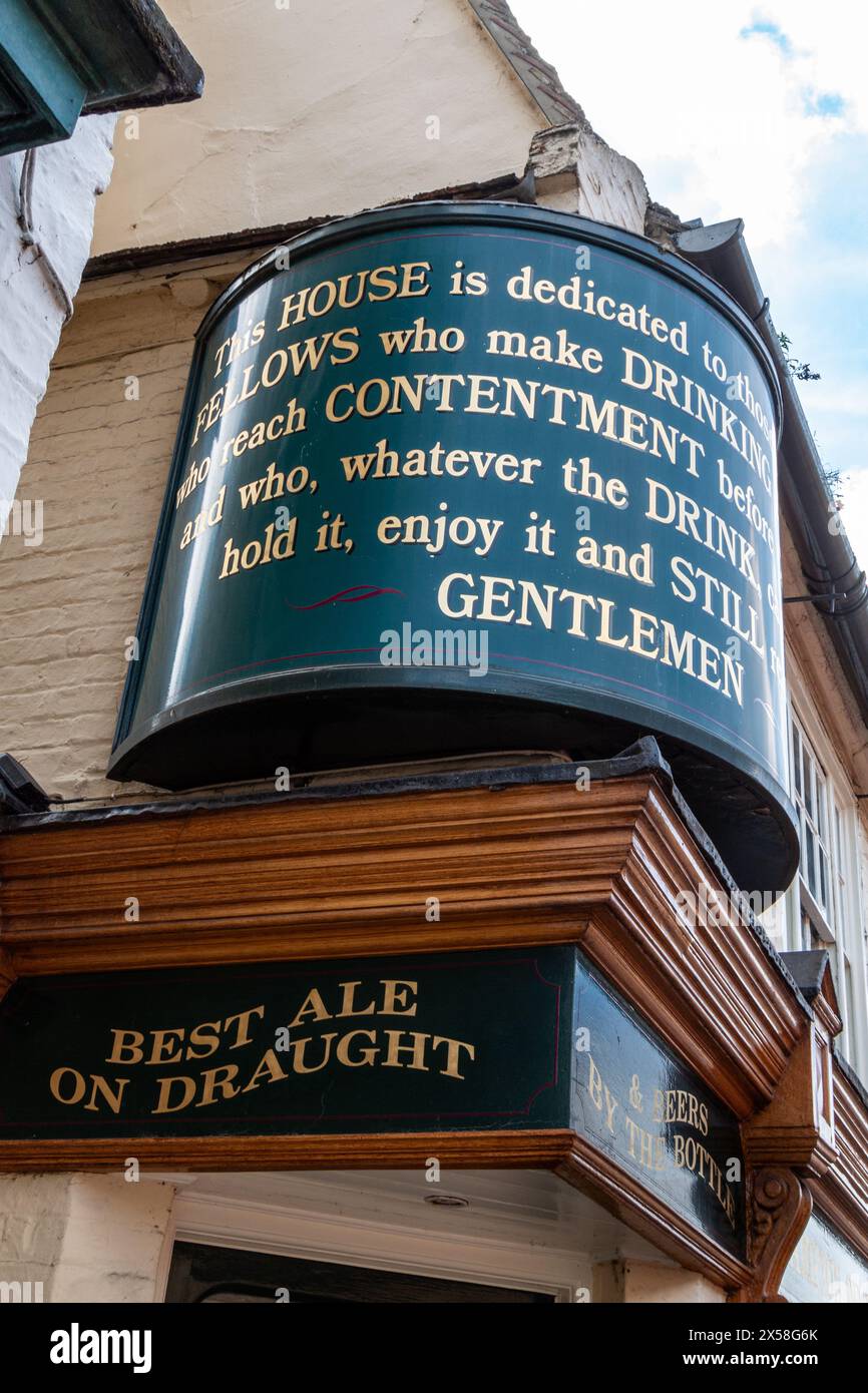 Traditional pub sign on the Champion of The Thames pub with text about contentment and drinking, Cambridge, England, UK Stock Photo